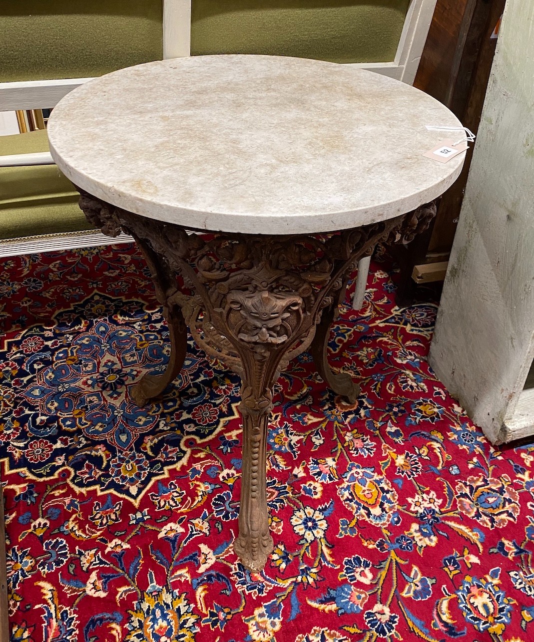 A Victorian style circular cast iron pub table with reconstituted marble top, diameter 60cm, height 73cm